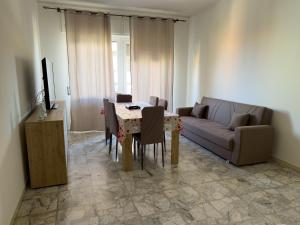 a living room with a couch and a table and chairs at CasaVacanzeRoseto in Roseto degli Abruzzi