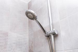 a shower with a shower head in a bathroom at CENTRAL Luxury 2BR Apartment Manchester in Manchester +28 photos
