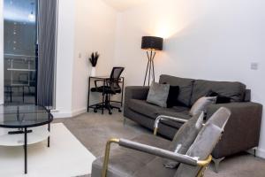 a living room with a couch and a table at CENTRAL Luxury 2BR Apartment Manchester in Manchester