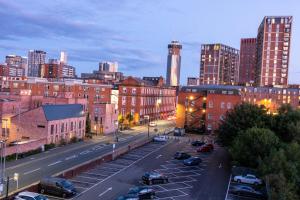 a city street with cars parked in a parking lot at CENTRAL Luxury 2BR Apartment Manchester in Manchester