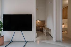 a flat screen tv on a white wall in a living room at Can Bo in Villajoyosa