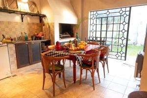 a kitchen with a table and chairs with fruit on it at La Casona del Parana in Paraná +9 photos