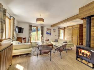 a living room with a couch and a fireplace at Chalet de standing spacieux avec terrasse et babyfoot - FR-1-344-1186 in Praranger