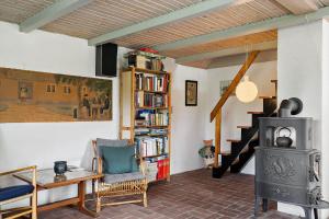 a living room with a wood stove and a staircase at 10008-Ulfborg-Kjaergaardvej-51 in Øhuse