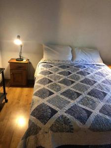 a bed with a quilt on it in a bedroom at El milagro in La Reja
