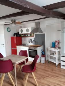 a kitchen with a table and chairs and a stove at Gästeoase einfach wohl fühlen in Wolfhagen