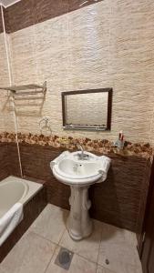 a bathroom with a sink and a tub and a mirror at Authentic boutique in Wadi Musa +22 photos