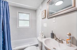 Un baño con lavabo, inodoro y espejo. en Whitehaven Park Retreat, en Memphis 52 fotos más
