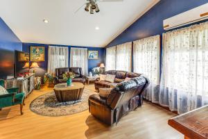 a living room with leather furniture and blue walls at Family-Friendly Home with Furnish Patio in Crystal! in Island Falls