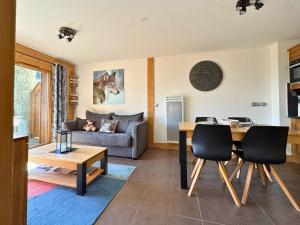 a living room with a table and a couch at Arpette Appartement 2/4 personnes au pied des pistes in Champagny-en-Vanoise