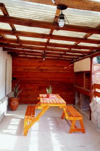 a patio with a picnic table and a bench at Cabañas Flor De Lis in Valle Hermoso