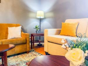 a living room with two chairs and a table at Cardinal Aerie in Madison +52 photos