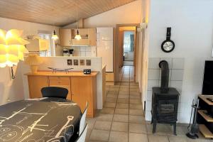 a kitchen and living room with a stove in it at 10768-Ulfborg-Svollingvej-83 in Øhuse