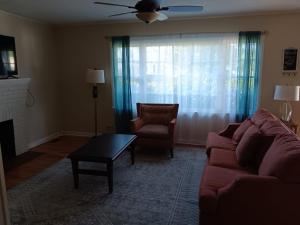 a living room with a couch and a chair at Bonita Bungalow in Huntsville