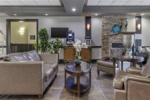 a waiting room with couches and a fireplace at Best Western Plus Chocolate Lake Hotel - Halifax in Halifax