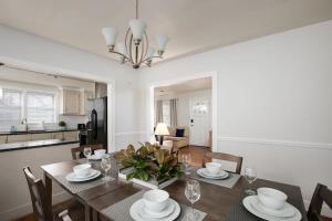 a dining room and kitchen with a table and chairs at 21st Ave Bham Bungalow in Homewood