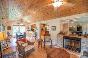 a living room with a fireplace and a table at Retriever Beach - New River-frontage with Your Own Private Beach! Fire Pits - Games and More! in Glendale Springs