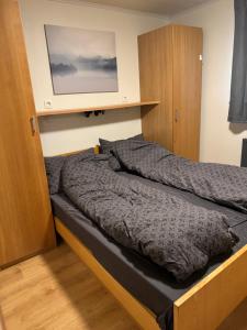 a bed in a bedroom with avertisementatronatronatronstrationstrationstration at Cabin on the Golden Circle in Úthlid