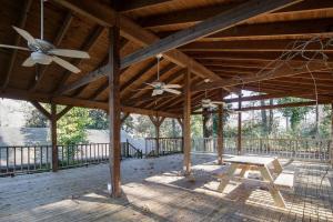 a porch with a ceiling fan and a picnic table at 21st Ave Bham Bungalow in Homewood