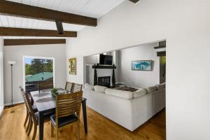 a living room with a couch and a table at Observatory Drive Terrace House in Irondale