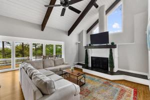 a living room with a couch and a flat screen tv at Observatory Drive Terrace House in Irondale