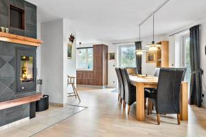 una sala da pranzo con tavolo e camino di 40711-Ulfborg-Hagevej-148 a Fjand Gårde