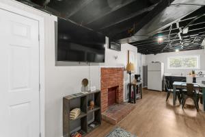 a living room with a brick fireplace and a kitchen at Broadmoor Bungalow - Unit B in Center Point +34 photos