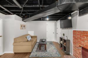 a living room with a couch and a fireplace at Broadmoor Bungalow - Unit B in Center Point