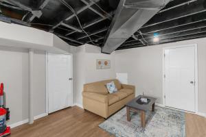 a living room with a couch and a table at Broadmoor Bungalow - Unit B in Center Point