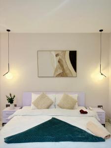 a bedroom with a white bed with a green rug on it at A Tranquil Studio in Airport Residential with Pool - The Essence in Accra