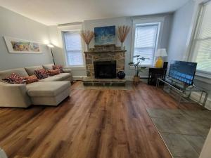 a living room with a couch and a fireplace at Cozy 2-BR Retreat Private Parking Near Downtown in Wilmington