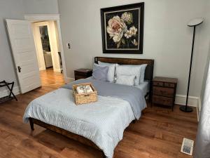 a bedroom with a bed with a basket on it at Cozy 2-BR Retreat Private Parking Near Downtown in Wilmington