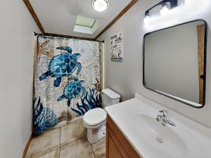 a bathroom with a sink and a mosaic shower curtain at Island Club #102 in Put-in-Bay +23 photos