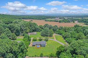 an overhead view of a farm house with a field and trees at Bethany A American Retreat in Rideout Village