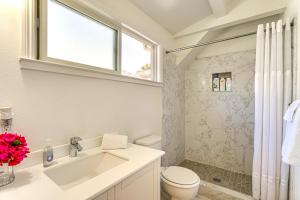 a bathroom with a sink and a toilet and a window at Walk to Dimond District Gems Home in Oakland in Oakland +20 photos