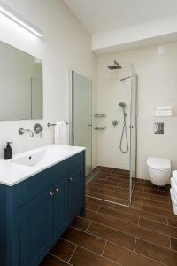 a bathroom with a sink and a shower and a toilet at Royal Retreat 6 Luxury Suites Villa & Pool in Herzliyya B