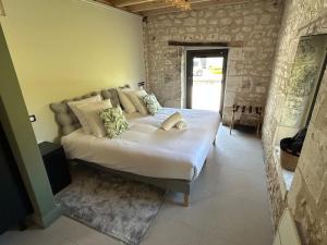 a bedroom with a large bed in a room at La Ruche Enchantée in Champigny-sur-Veude +23 photos