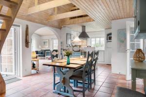a kitchen and dining room with a table and chairs at 10732-Ulfborg-Svollingvej-94 in Ulfborg