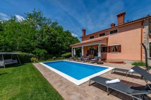 a swimming pool in the yard of a house at Villa Ornela, summer and sun, ideal for families and pets! in Santalezi