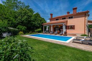 a villa with a swimming pool in front of a house at Villa Ornela, summer and sun, ideal for families and pets! in Santalezi