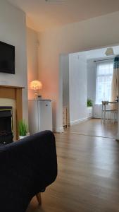a living room with a couch and a fireplace at House 36 in Liverpool