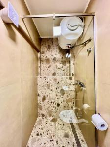 a bathroom with a shower with a glass door at Douloudis Luxury Apartment in Alexandroupoli