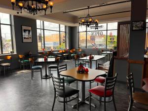 a dining room with tables and chairs and windows at 4th Street Lofts in Bemidji