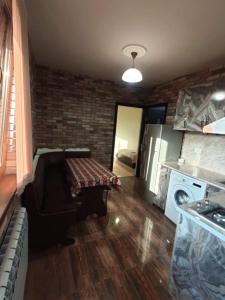 a kitchen with a couch and a washer and dryer at частный дом, с двором in Vanadzor