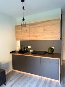 a kitchen with a wooden counter top with a sink at Apartament Roma in Pniewy