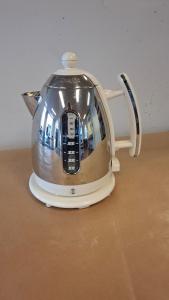a silver tea kettle sitting on top of a table at Downtown with balcony in Tønsberg