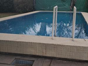a swimming pool with two poles in the water at casa quinta in Toay
