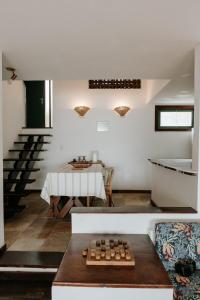 a living room with a table and a dining room at Casa em Búzios com vista espetacular in Búzios