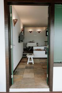 a room with a table and a bench in a room at Casa em Búzios com vista espetacular in Búzios