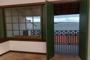 a room with a window with a view of the water at Casa em Búzios com vista espetacular in Búzios +44 photos